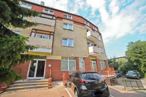 a car parked in front of a brick building at Aparment near Monte Cassino by Grand Apartments in Sopot +3 photos