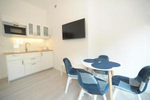 a kitchen with a table and chairs and a tv at Aparment near Monte Cassino by Grand Apartments in Sopot