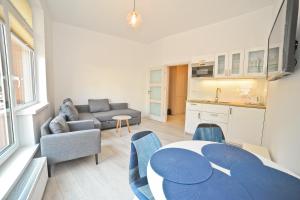 a kitchen and a living room with a table and chairs at Aparment near Monte Cassino by Grand Apartments in Sopot