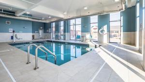 a swimming pool in a building with blue walls at Holiday Inn Express & Suites Platteville, an IHG Hotel in Platteville