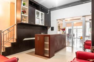 a living room with a counter and a staircase at RedDoorz near Manhattan Times Square Medan 2 in Medan