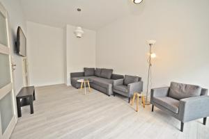 a living room with two couches and a tv at Family apartment 50 m from Monte Cassino by Grand Apartments in Sopot