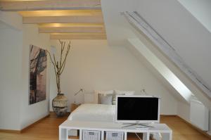 a bedroom with a white bed and a tv on a table at apartments&co in Wolfsburg