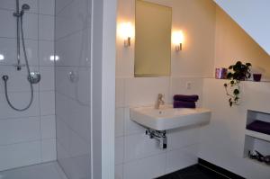 a bathroom with a sink and a shower at apartments&co in Wolfsburg