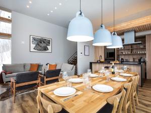 a dining room with a large wooden table and chairs at Chalet Ukiyo in Niseko