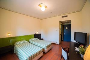 A bed or beds in a room at Orizzonte Acireale Hotel