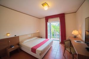 A bed or beds in a room at Orizzonte Acireale Hotel