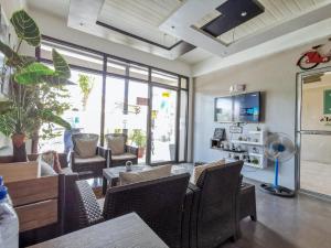 a living room with chairs and a table and a tv at RedDoorz near Gaisano Mall Gensan in General Santos