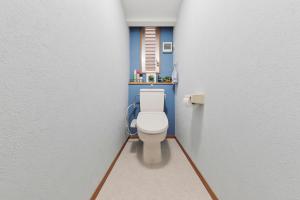 a small bathroom with a toilet in a room at Terrace Terano#101 in Tokyo
