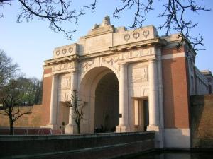 a large building with an arch in front of it at LE CHAT NOIR in Ieper