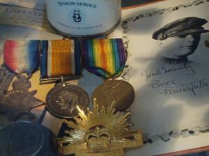 a group of medals on top of a paper at LE CHAT NOIR in Ieper