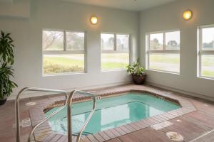 a swimming pool in a house with windows at Holiday Inn Express Hotel & Suites Arcata/Eureka-Airport Area, an IHG Hotel in McKinleyville