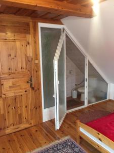 a room with a sliding glass door and a bathroom at Agro privat in Hrabušice