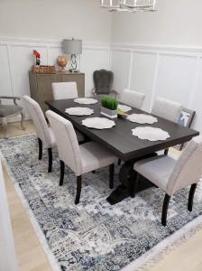 a black dining room table with chairs on a rug at Spacious & Bright home In Bloomingdale/ Truxton DC in Washington, D.C.
