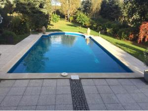 a swimming pool in a yard with a garden at B OUR GUEST at NEW FLAT NEARBY DRESDEN !!!POOL!!! in Frauendorf