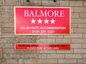 
a sign on the side of a brick building at Balmore Guest House in Edinburgh
