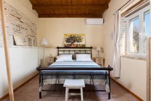 a bedroom with a bed in a room with a brick wall at The Swallow's Seaview Nest by Konnect in Ágios Márkos
