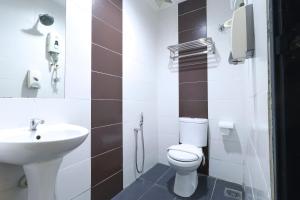 a bathroom with a toilet and a sink at Suite Dreamz Hotel in Kuala Lumpur