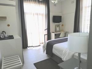 TV a/nebo společenská místnost v ubytování The Hampton Exclusive Guesthouse