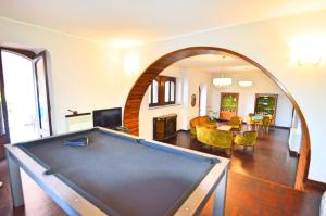 a pool table in the middle of a living room at Villa La Timpa - antica e maestosa villa con jacuzzi privata con una meravigliosa vista sull'Etna e sul mare in Acireale