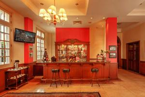 a bar in a room with red walls at Du Parc Hotel Dalat in Da Lat