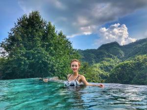 a young girl in the water in the ocean at No.5 Valley Lodge in Zhangjiajie