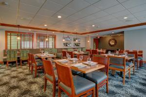 um restaurante com mesas e cadeiras num quarto em Holiday Inn Milwaukee Airport, an IHG Hotel em Milwaukee