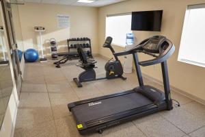 a gym with two exercise bikes and a treadmill at Holiday Inn Express and Suites Tahlequah, an IHG Hotel in Tahlequah