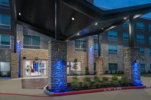 a building with blue lights in front of it at Holiday Inn Express & Suites- Sugar Land SE - Missouri City by IHG in Missouri City