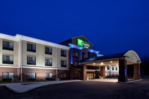 a hotel building with a lit up sign on it at Holiday Inn Express & Suites Zanesville North by IHG in Zanesville