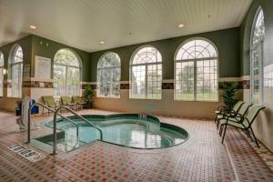 a large indoor pool in a room with windows at Holiday Inn Milwaukee Airport, an IHG Hotel in Milwaukee