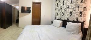 Postel nebo postele na pokoji v ubytování Hotel Métropole Résidence
