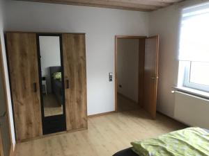 an empty room with a mirror and a door at Ferienwohnung Weserbergland Haus Nr 29 Erdgeschoss in Deensen