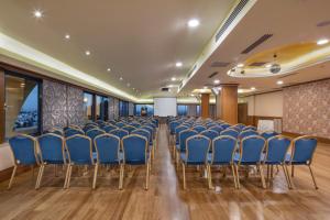 a room with blue chairs in a conference room at Merit Lefkosa Hotel & Casino in North Nicosia +37 photos