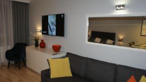 Televízia a/alebo spoločenská miestnosť v ubytovaní Apartament Agata