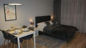 A bed or beds in a room at Apartament Agata