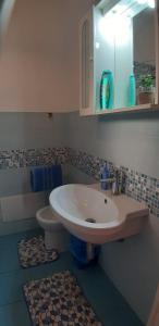 a bathroom with a sink and a toilet at Il Girasole in SantʼAntìoco