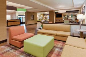a lobby with a couch and chairs and a table at Holiday Inn Express Hotel & Suites Huntsville West - Research Park, an IHG Hotel in Huntsville
