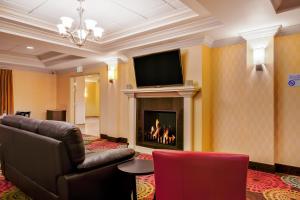 a living room with a couch and a fireplace at Holiday Inn Express and Suites Missoula, an IHG Hotel in Missoula