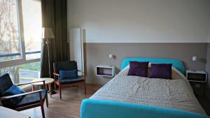 a bedroom with a blue bed and two chairs at Little Suite - Constance in Lille