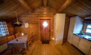 a dining room with a table and a door at Ulvö Lakeside Resort in Ulvöhamn