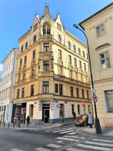 a large yellow building on a city street at Reznicka Apartments in Prague