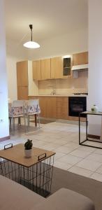 a large kitchen with a table and chairs in it at San Sisto Residence - Foligno City Center - La Montagnola Affittacamere in Foligno