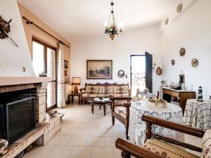a living room filled with furniture and a fireplace at Holiday villa with sea view in Paralia Avlidas in Dhílesi