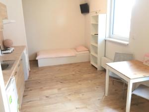 a small room with a table and a bed at Apartments U Flóry in Olomouc +13 photos