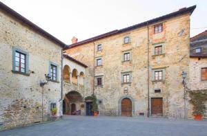 a large stone building with a street in front of it at Gredo Antica Dimora in Villafranca in Lunigiana