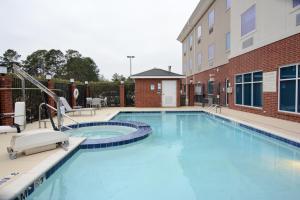 a large swimming pool in front of a building at Holiday Inn Express Hotel & Suites New Boston, an IHG Hotel in New Boston