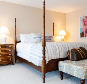 a bedroom with a bed and a lamp at Bayview Hotel in Bar Harbor