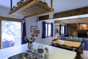 a kitchen and living room with a sink and a table at Katsos Ranch Retreat in Vail