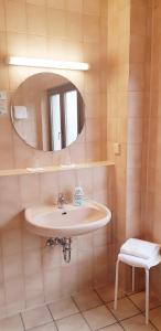 a bathroom with a sink and a mirror at Hotel Baeren in Leimen